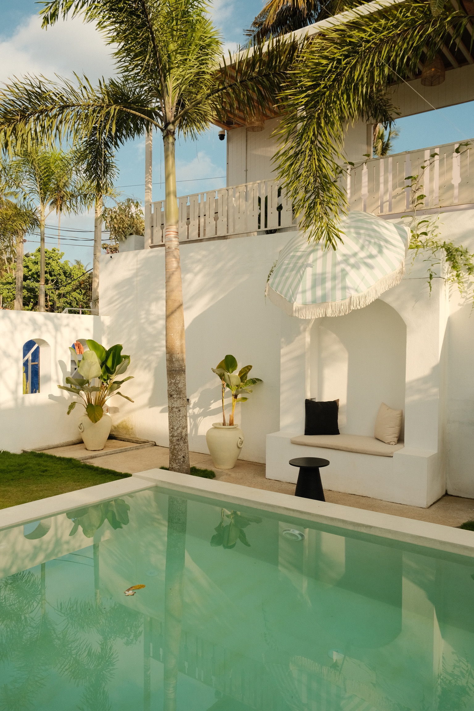 The boutique villa and pool, palm-shaded